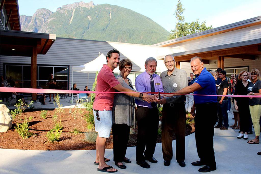Photo by Natalie DeFord                                Brenden Elwood, Jeanne Pettersen, Mayor Ken Hearing, Alan Gothelf and Ross Loudenback perform the ribbon cutting at a special ceremony at North Bends new City Hall Sept. 5.