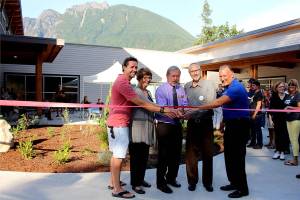 Photo by Natalie DeFord                                Brenden Elwood, Jeanne Pettersen, Mayor Ken Hearing, Alan Gothelf and Ross Loudenback perform the ribbon cutting at a special ceremony at North Bends new City Hall Sept. 5.