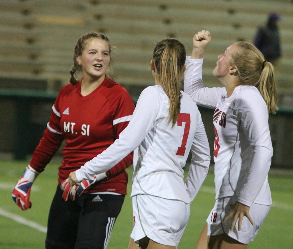 Mount Sis Kylie Hunter, Maddie Lilleberg and Maggie Mitchell get hyped up for the second half against North Creek. Andy Nystrom/ staff photo