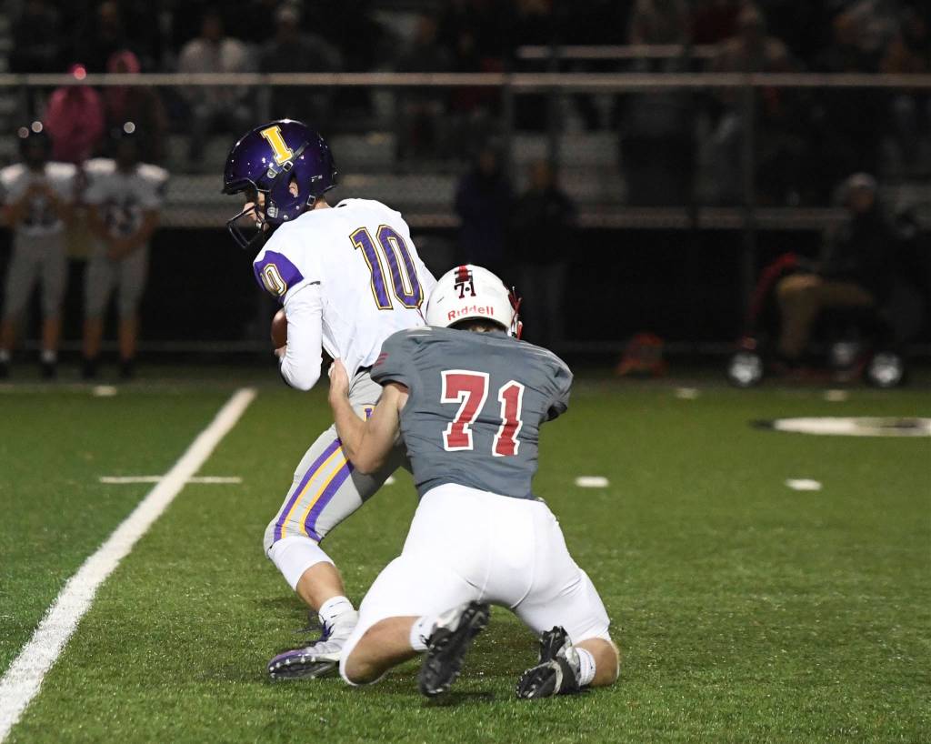 Mount Si defensive lineman Anthony Gilden wraps up Issaquah quarterback Jack Githens for a sack during the Wildcats 34-0 shutout victory over Issaquah on Oct. 11. Photo courtesy of Calder Productions
