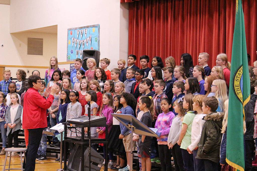Desi Cuddihys fourth grade class sing patriotic songs at Snoqualmie Elementarys Veterans Day assembly. Madison Miller / staff photo