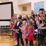 Four of Desi Cuddihys fourth grade class students lead the 11th annual Snoqualmie Elementary Veterans Day assembly on Nov. 8. From left: Emery Giles, Gabriel Natarajan, Rachel Rigby and Annabelle Nieman. Madison Miller / staff photo