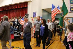 Desi Cuddihys fourth-grade students welcome veterans, including Navy veterans Mark and Angie Kennedy (center) as they enter the Snoqualmie Elementary Veterans Day assembly on Nov. 8. Madison Miller / staff photo