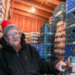Volunteer David Olson organizing food into stacks at the Snoqualmie Valley Food Bank. Natalie DeFord/staff photo