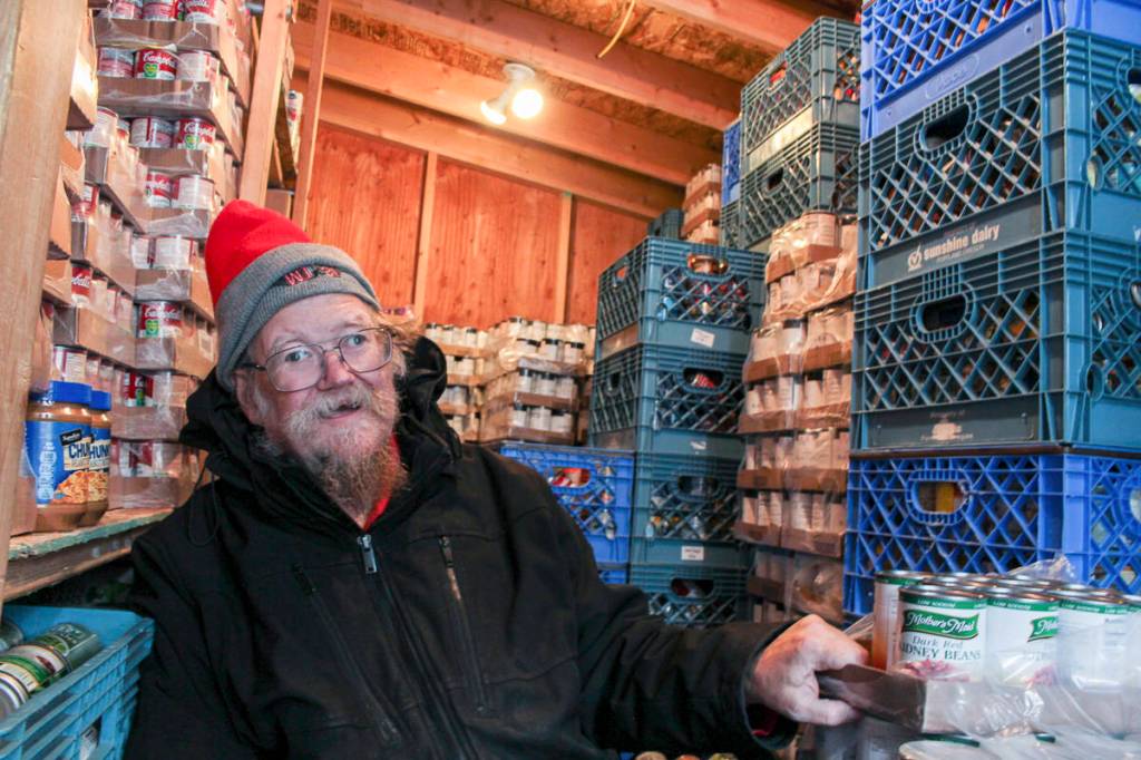 Volunteer David Olson organizing food into stacks at the Snoqualmie Valley Food Bank. Natalie DeFord/staff photo