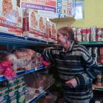 Heather Walsh, Snoqualmie Valley Food Bank operations manager, stocks a bread shelf. Natalie DeFord/staff photo