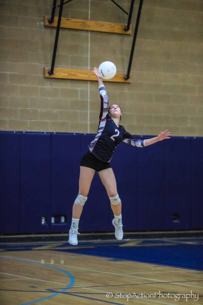 Wildcat Dana Dolan fires off a serve against Issaquah. Photo courtesy of Don Borin