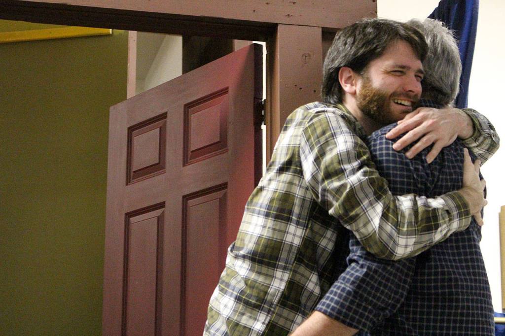 Ryan Hartwell (Fred) hugs Tim Platt (Scrooge) in the final scene of VCSs production of A Christmas Carol. Madison Miller / staff photo