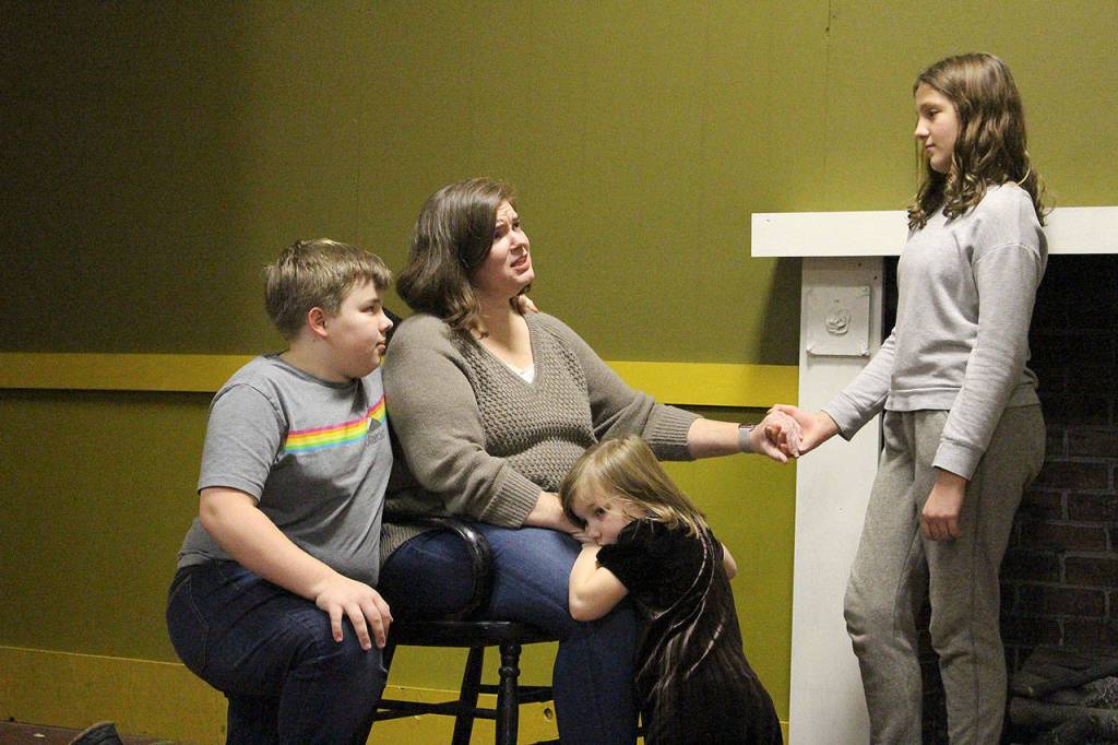 April Davis and her family star as the Cratchit family in VCSs production of A Christmas Carol. From left: Joseph Beegle, April Beegle, Hazel Beegle and Grace Combs. Madison Miller / staff photo
