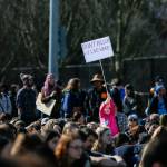 A young girl holds up a Dont Pollute I Live Here sign in the crowd during the Youth Climate Strike at Cal Anderson Park on Friday, March 15, 2019 in Seattle, Wash. (Olivia Vanni / The Herald)
