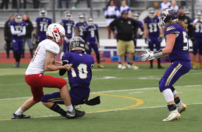 Mount Si defensive lineman Anthony Gilden (left) sacks Lake Stevens quarterback Tanner Jellison (middle) during the Wildcats 24-22 win on Nov. 23. Photo courtesy of Calder Productions
