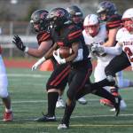 Mount Si defenders Andrew Edson (85) and Caleb Dalgleish chase after Camas running back Jacques Badolato-Birdsell (middle) during a 4A state semifinal on Nov. 30. Photo courtesy of Calder Productions