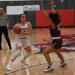 Mount Si senior Izzy Smith (left) looks to make a pass during the Wildcats 56-37 victory over Holy Names on Dec. 4. Photo courtesy of Calder Productions