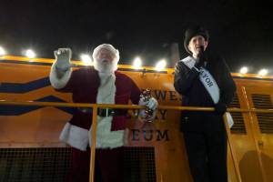Santa waves to the crowd as Snoqualmie Mayor Matt Larson leads the crowd in an acapella version of Santa Claus is Coming to Town during the annual Winter Lights on Dec. 7. Corey Morris/staff photo