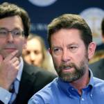 Washington state Attorney General Bob Ferguson (left) looks on as Paul Kramer, the father of a teenage son who survived a mass shooting in Mukilteo, speaks at a news conference announcing legislation to combat mass shootings in the state, Thursday in Seattle. (AP Photo/Elaine Thompson)