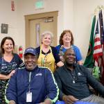 Stephanie Quiroz/staff photos                                Above from left: Mary Anne Coward, Edwin Bailey, Judy Anware, Pam Mueller and Alonzo Mitz on Dec. 13.                                Right, Seahawks legend Alonzo Mitz signs Herb Altmanns 12s flag at Sno-Valley Senior Center.