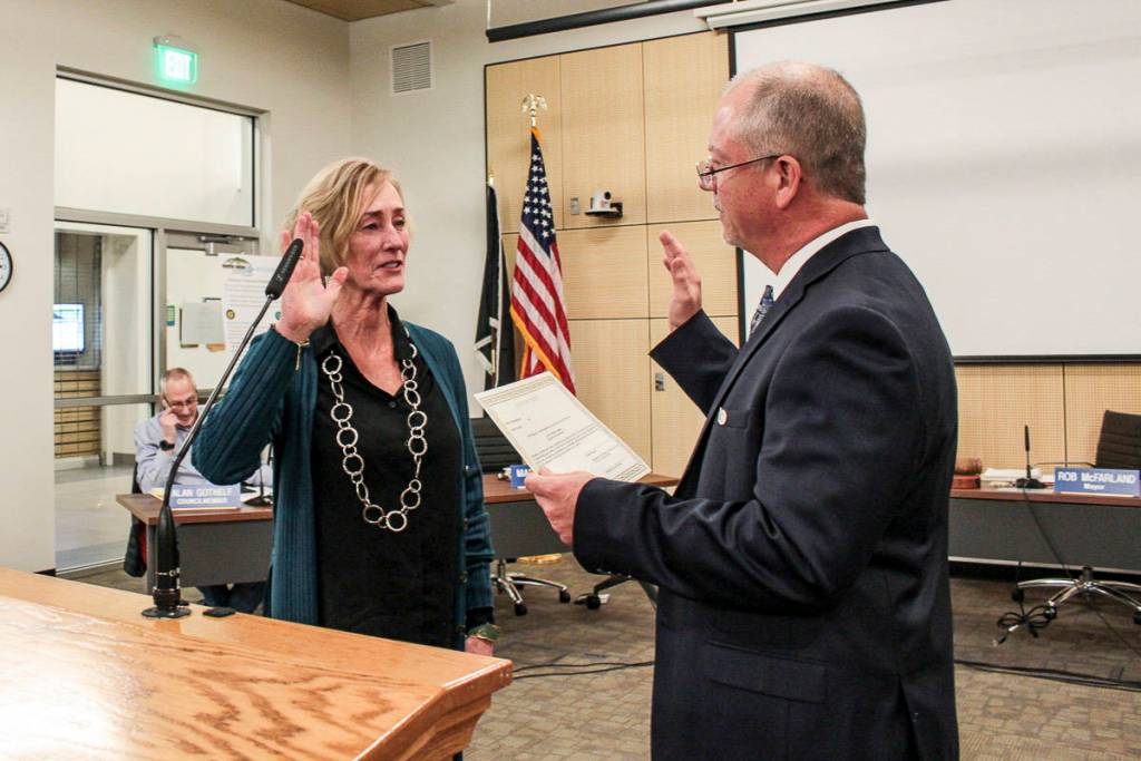 Natalie DeFord/staff photo                                North Bend Mayor Rob McFarland swears in new Councilmember Mary Miller at the Jan. 7 council meeting.