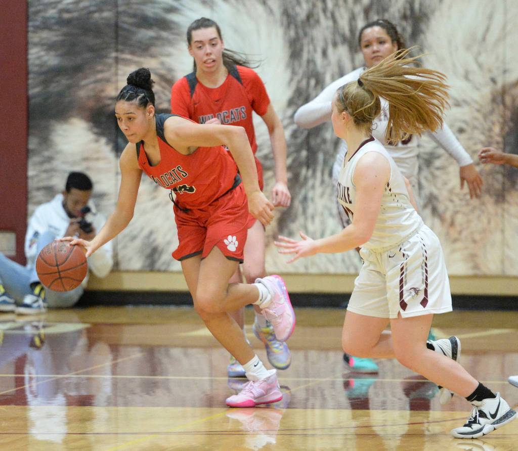 Mount Si freshman Makhayla Adams (left) dribbles the ball during the Wildcats victory over Eastlake on Jan. 17. Adams had a career-high eight points in the win. Photo courtesy of Calder Productions