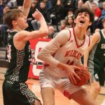 Wildcat Hayden Curtiss battles his way to the hoop against Skyline. Andy Nystrom/ staff photo