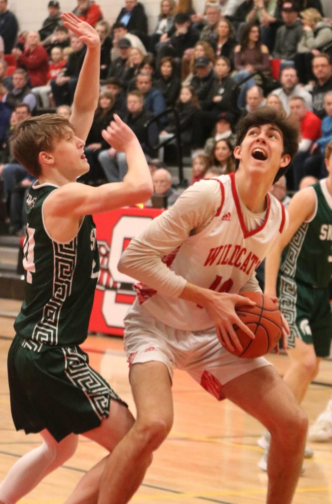 Wildcat Hayden Curtiss battles his way to the hoop against Skyline. Andy Nystrom/ staff photo