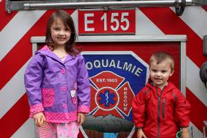 6-year-old Finley Gendron (left) and her little brother, Boston Gendron, explore the citys fire truck during Big Truck Day in 2019. File photo