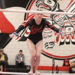 Mount Sis Tylor Zwiefelhofer jumps to the high bar during her bars routine during the event finals at the 4A state gymnastics meet on Feb. 22 at Sammamish High School. Benjamin Olson/staff photo