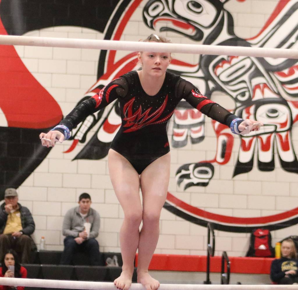 Mount Sis Tylor Zwiefelhofer jumps to the high bar during her bars routine during the event finals at the 4A state gymnastics meet on Feb. 22 at Sammamish High School. Benjamin Olson/staff photo