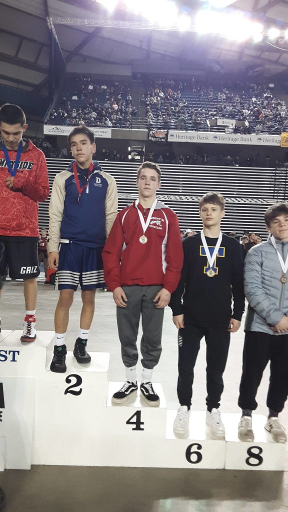 Mark Marum, third from left, receives his fourth-place medal at state. Andy Nystrom/ staff photo