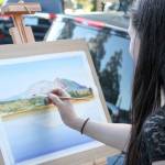 Jacqueline Tribble painting during a previous Finally Friday Art and Wine Walk event. Courtesy photo