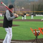 Head coach Brent Lutz hits infield practice on March 10. Andy Nystrom/ staff photo
