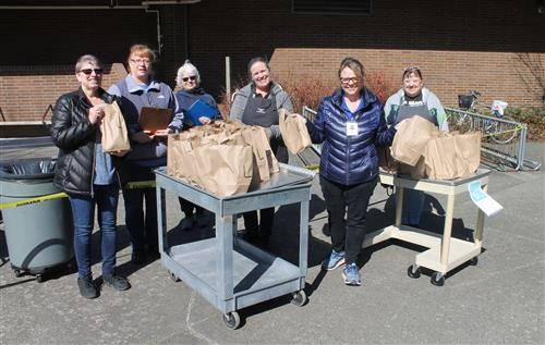 Photo courtesy of Carolyn Malcolm                                 Snoqualmie Valley School District food services staff hands out meals to students on March 19 at Opstad Elementary. From left, Director Pam Chambers with team members Cheryl Tracy, Barbie Travis, Danielle Wood, Michele McDaniel and Debbie Johnson.