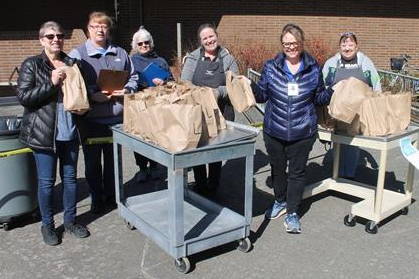 Photo courtesy of Carolyn Malcolm                                 Snoqualmie Valley School District food services staff hands out meals to students on March 19 at Opstad Elementary. From left, Director Pam Chambers with team members Cheryl Tracy, Barbie Travis, Danielle Wood, Michele McDaniel and Debbie Johnson.