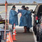 Drive-thru COVID-19 virus testing last week in the parking lot near Everett Memorial Stadium in Everett. A study by the University of Washington and UnitedHealth Group, conducted at Everett Clinic locations, found that a less-intrusive form of the coronavirus test would require fewer precautions by health care workers. (Andy Bronson / The Herald)