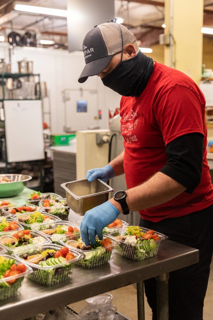 Dan Kiley, executive chef at Lisa Dupar Catering, prepares Mediterranean salads for Medic One Foundations Gratitude Meals program. Photo courtesy of Hannah Sheil