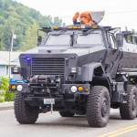 Snoqualmie Police Department houses a surplus military mine-resistant armored personnel carrier. They acquired it as part of an equipment sharing program from the federal government. It is utilized by a coalition of small-city police departments. It is seen here during a 2016 parade in Algona, one of the coalition member cities. From the Algona Police Department Facebook page