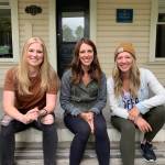 The co-founders of Aroma Coffee sit on the porch of their new coffee shop. From left to right: Kelsey Wilson, Sara Cox and Emily Ridout. Contributed by Emily Ridout.