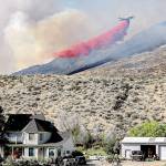 A plane drops fire retardant on the Palmer Mountain Fire last week. The fire is listed as 84 percent contained, and fully lined. Laura Knowlton/Sound Publishing staff photo