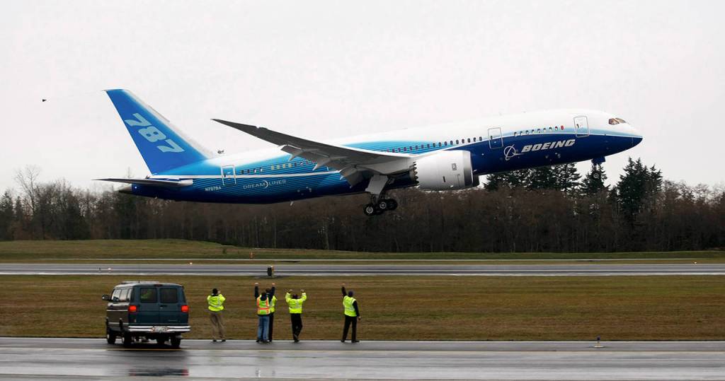 Workers cheer and wave as Boeings 787 Dreamliner takes off from Paine Field on Dec. 15, 2009. (Justin Best/ Herald file)