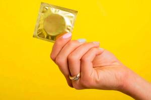 Woman holding a condom. Courtesy photo