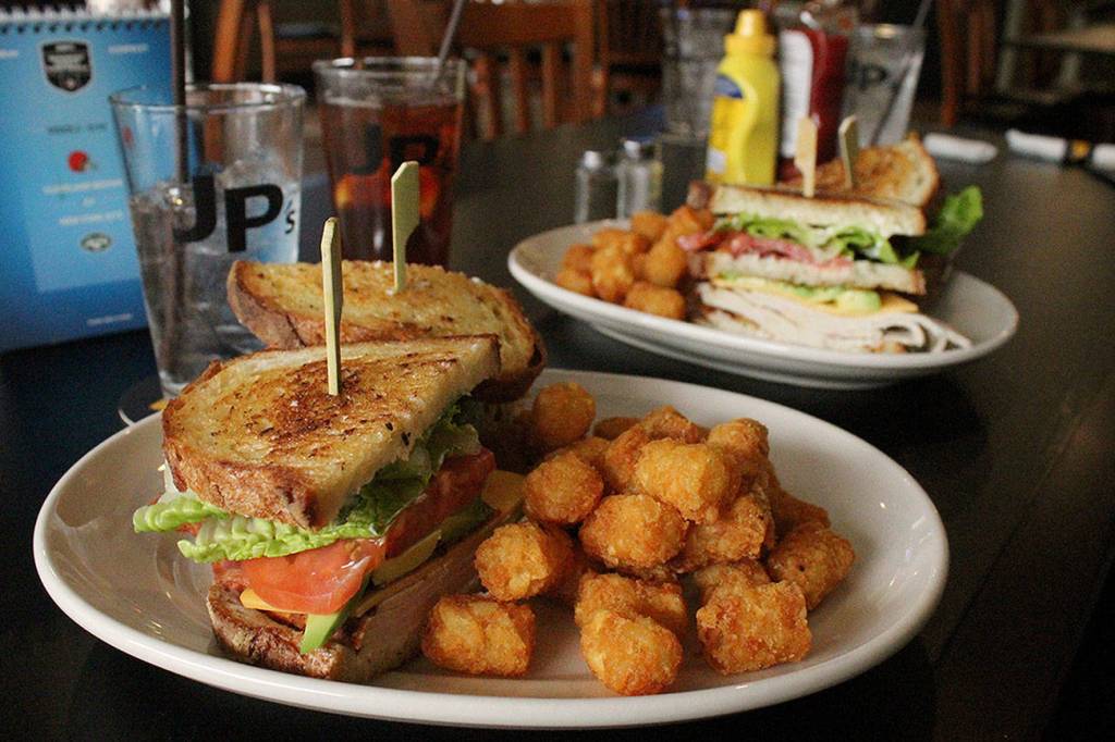 Local restaurants have had to adapt to new rules during the COVID pandemic. Pictured: JPs Tavern in Federal Ways turkey club sandwich with a side of tater tots. File photo