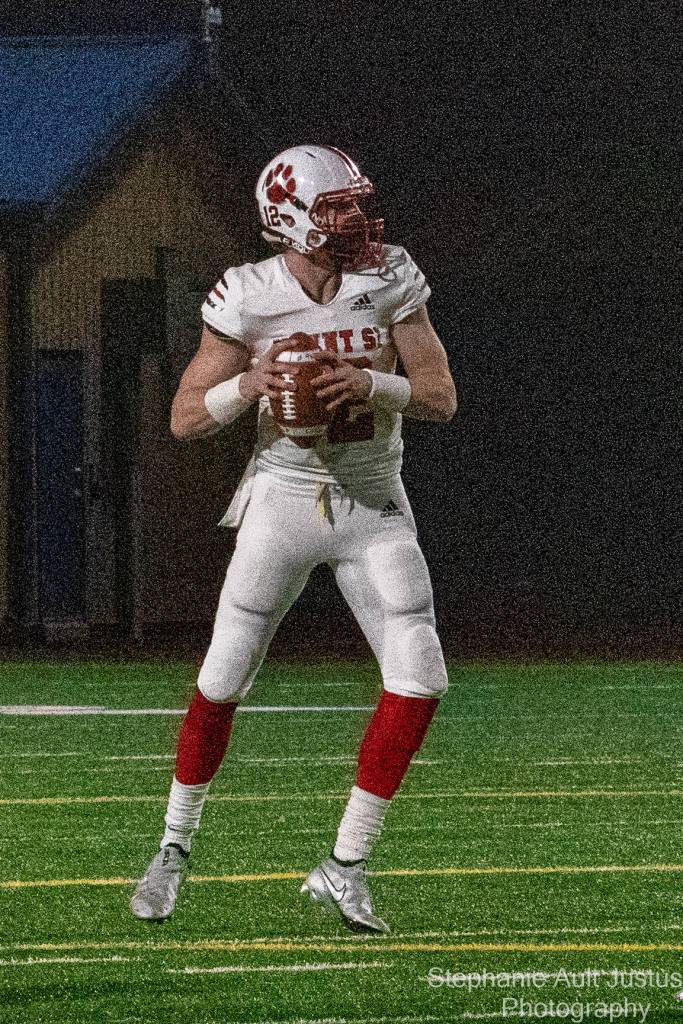 Mt. Si senior quarterback Clay Millen looks for a receiver to connect with during the Wildcats 23-13 victory over Bellevue on March 12. On one play in the second half, Millen broke free from three Bellevue tacklers and threw the ball 30 yards for a touchdown. Millen nailed two touchdown passes to Zach Soliday and one to Jacob Shaffer. Photo courtesy of Stephanie Ault Justus