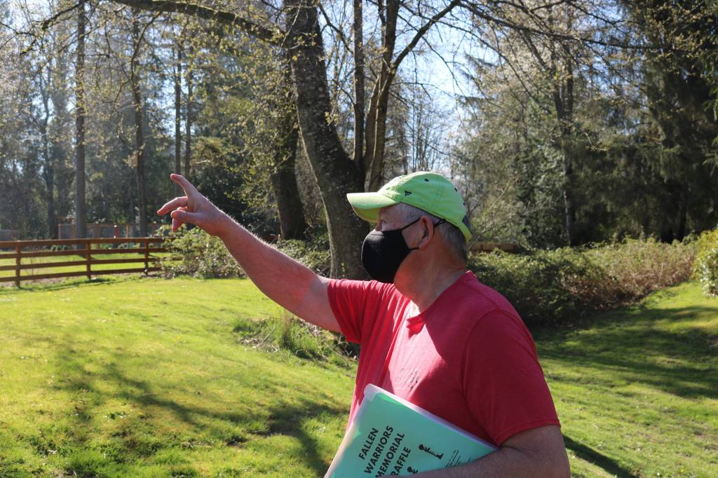 Jim Curtis points to Mount Si, which overlooks EJ Roberts park. He wants to rename the park to Five Eagles Park as a subtle way to honor veterans of the five branches of the U.S. military. Aaron Kunkler/staff photo
