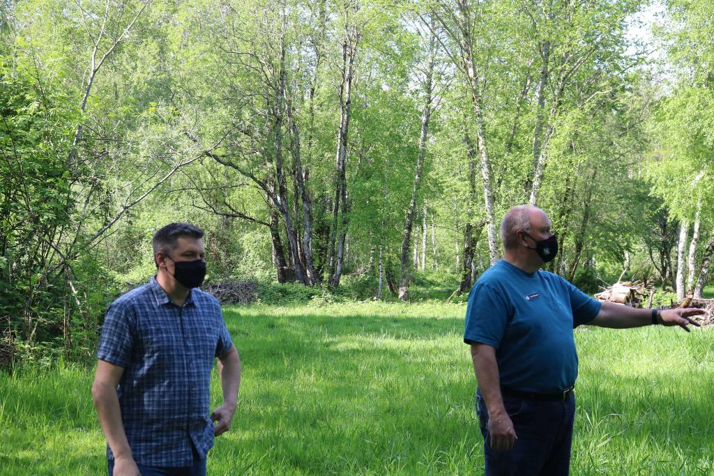 Aaron Kunkler/Staff photo
Joel Yoker (left) and Joe Hannan stand in the rear 15-acres of their 20-acre property. The back portion of the property consists of a large meadow ringed by thick groves of trees.