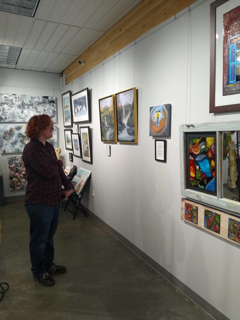 Charlie Hoopman inspecting his artwork. Contributed by Two Rivers High School