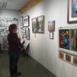 Charlie Hoopman inspecting his artwork. Contributed by Two Rivers High School