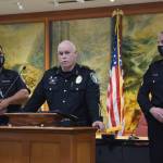 Police Chief Perry Phipps (center), speaks to promoted sergeants, at Oath of Office ceremony Aug. 9. (left) Nigel Draveling and Jason Weiss (right). Photo by Conor Wilson