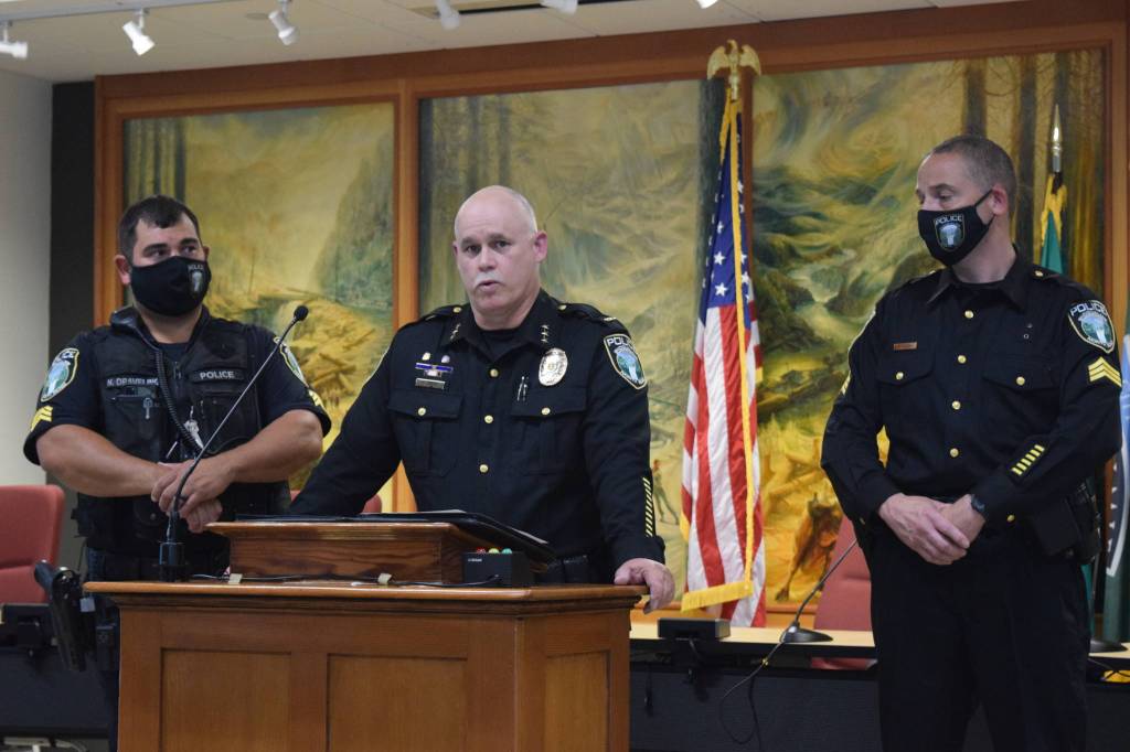 Police Chief Perry Phipps (center), speaks to promoted sergeants, at Oath of Office ceremony Aug. 9. (left) Nigel Draveling and Jason Weiss (right). Photo by Conor Wilson
