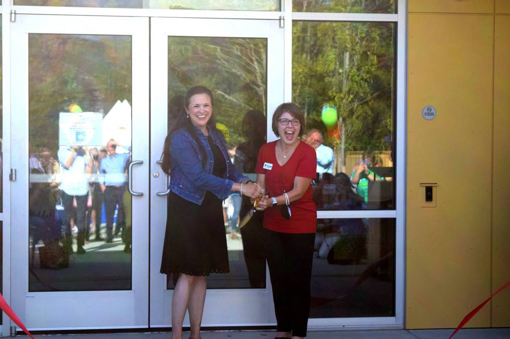 Rebekah McHugh and Encompass Executive Director Nela Cumming cut the ribbon at the Child Development Centers grand opening on Aug. 19. Photo by Conor Wilson/Snoqualmie Valley Record