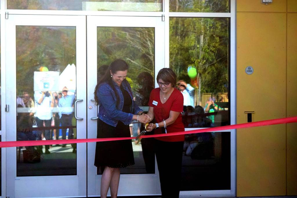 Rebekah McHugh and Encompass Executive Director Nela Cumming cut the ribbon at the Child Development Centers grand opening on Aug. 19. Photo by Conor Wilson/Snoqualmie Valley Record