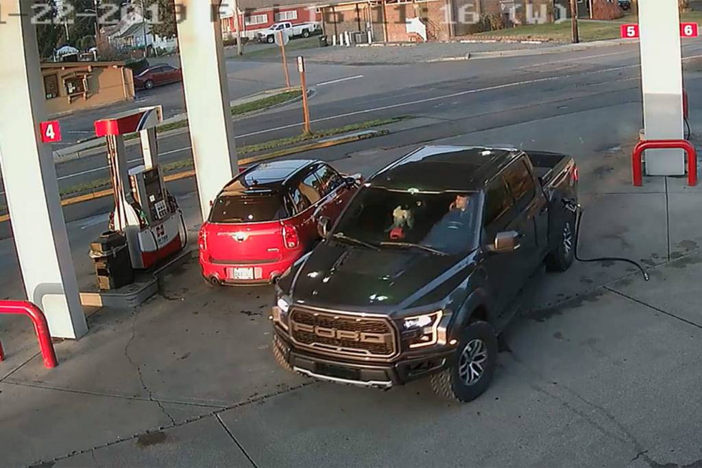 This 2019 security footage at the Cenex gas station in Black Diamond shows Anthony Chilcott on his phone before entering, and driving off with, Carl Sanders Ford Raptor and Monkey, his poodle, in the front seat. Courtesy photo